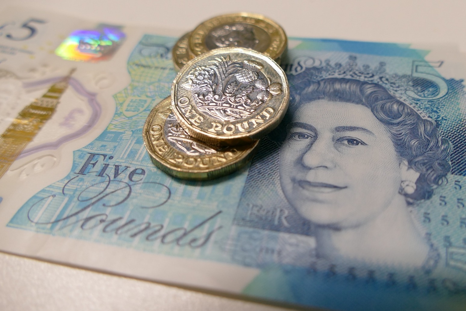 Sterling revisits 2-year lows as UK economy shrinks 
